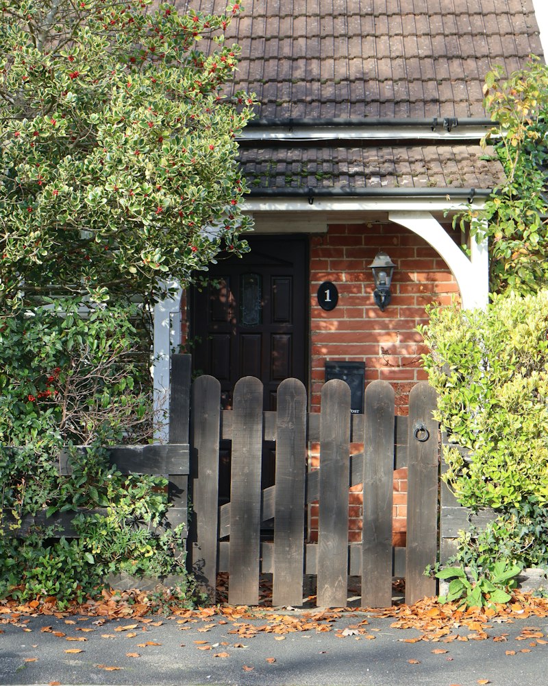 Garden gate at the entrance of a brick home