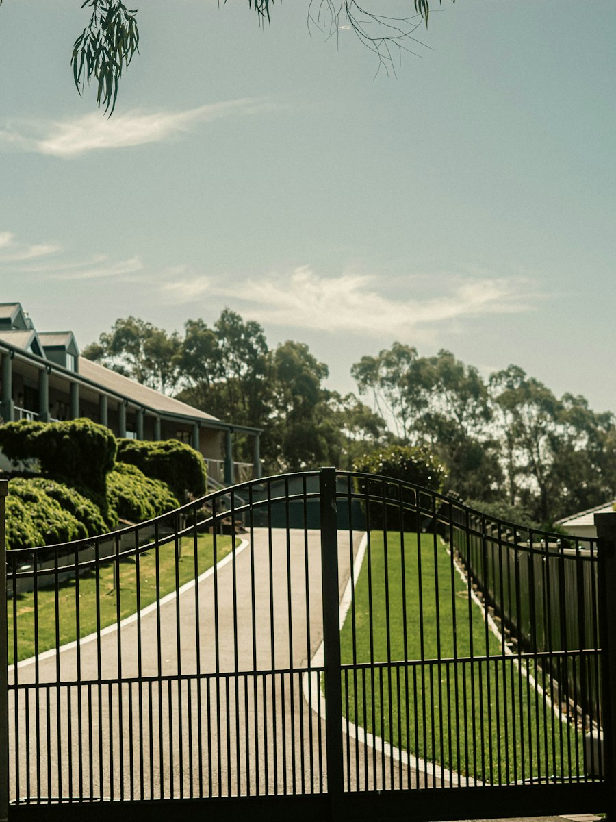 Automatic driveway gate leading to a landed home