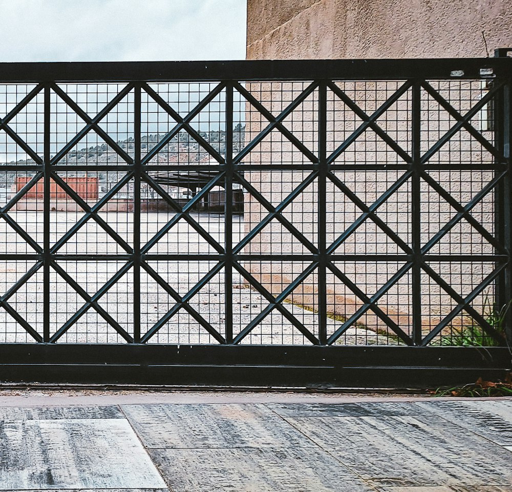 Black steel sliding gate with a diamond lattice